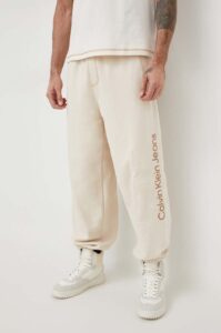 Bavlněné tepláky Calvin Klein Jeans béžová